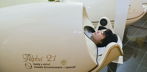 A woman enters the Alpha 21 relaxation machine