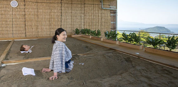 A woman relaxing in the sand bath